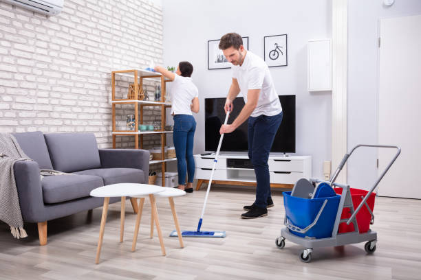 istock Two Young Janitors Cleaning The Living Room 1128875540