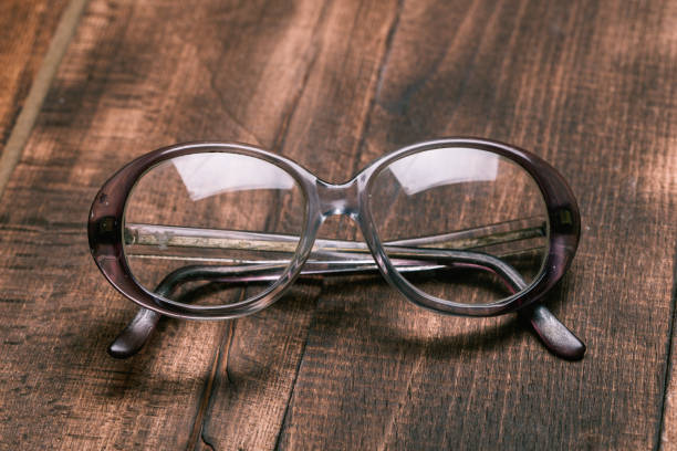 istock A pair of glasses on a wooden table 1128875541