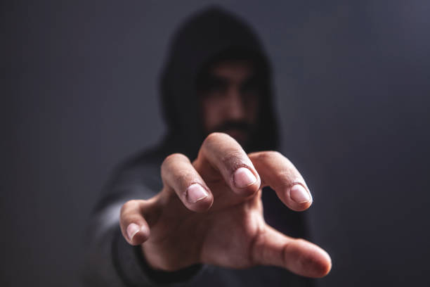 istock man in hood close up 1128876160