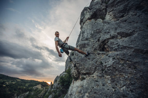 istock Disability man free climbing on rock mountain 1128876556