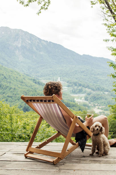 istock nice dog is sitting near the man with juice 1128877049