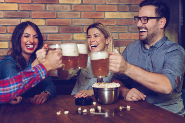 istock Group Of Friends Enjoying Evening Drinks In Bar 1128878309