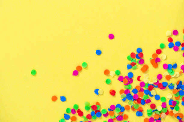 istock Confetti carnival decoration yellow background 1128879389