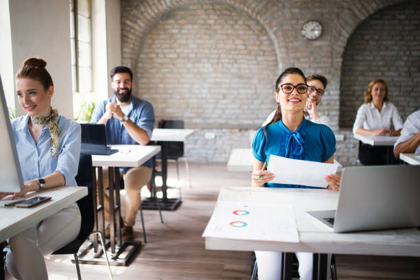 istock Successful happy group of people learning software engineering and business during presentation 1128880561