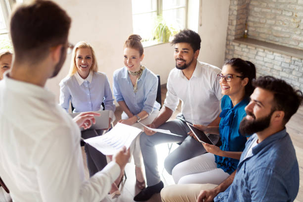istock Successful happy group of people learning software engineering and business during presentation 1128880612