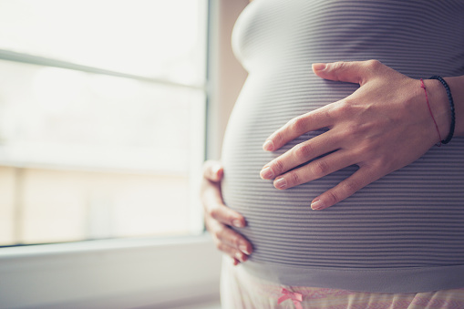 Close up woman touching her belly