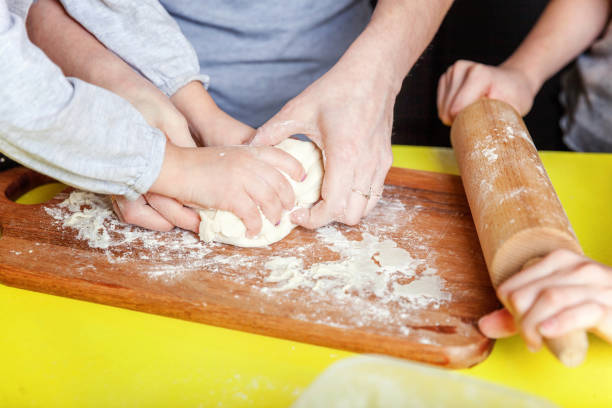 istock Mother and children cooking in kitchen and having fun 1128881493
