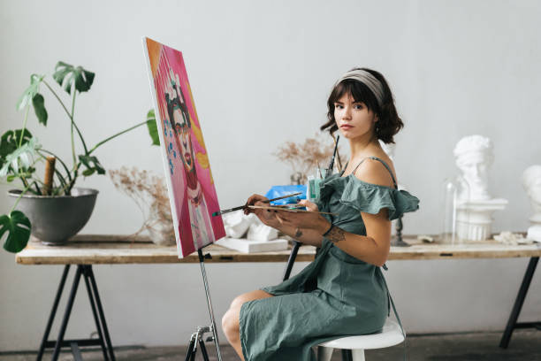 istock Artist painting in her studio 1128882021