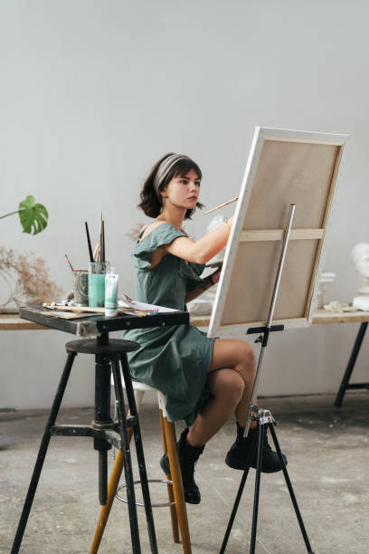 istock Artist painting in her studio 1128882104