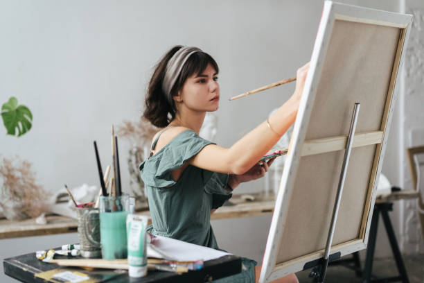 istock Artist painting in her studio 1128882133