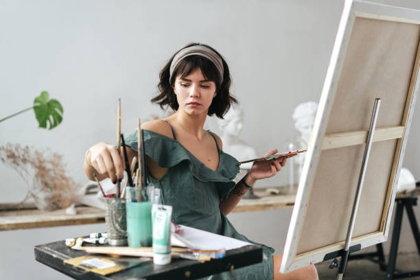 istock Artist painting in her studio 1128882144