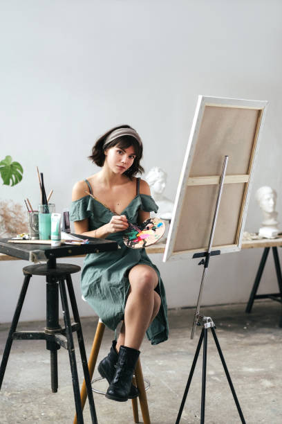 istock Artist painting in her studio 1128882165