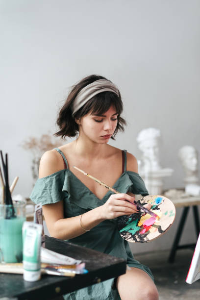 istock Artist painting in her studio 1128882169