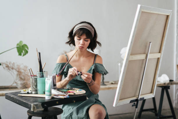 istock Artist painting in her studio 1128882185