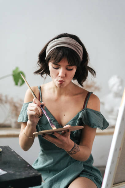 istock Artist painting in her studio 1128882203