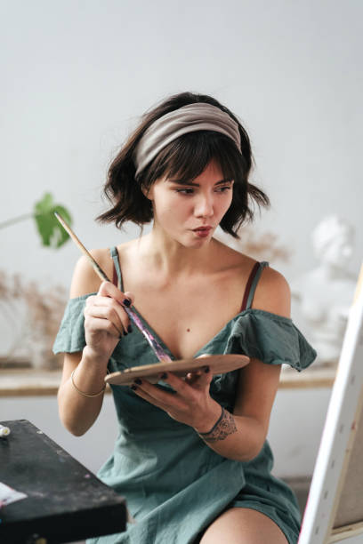 istock Artist painting in her studio 1128882204