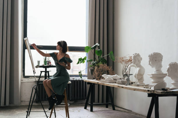 istock Artist painting in her studio 1128882232