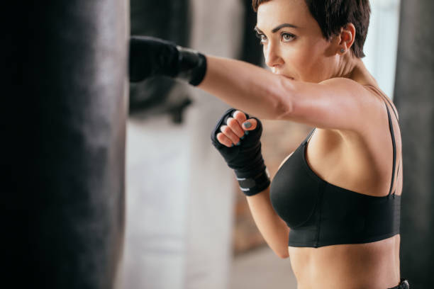 istock close up cropped image of serious plucky athlete developing kickboxing skills 1128883636