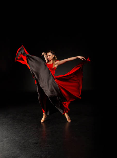 istock Graceful ballet dancer or classic ballerina dancing isolated on dark studio. 1128884340