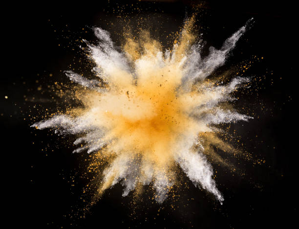 istock Silver and gold powder explosion on black background. 1128884963