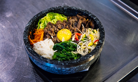 Traditional Korean bibimbap meal is served on the table