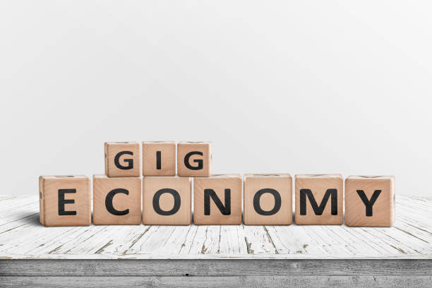 Gig economy sign made of wood on a worn table stock photo