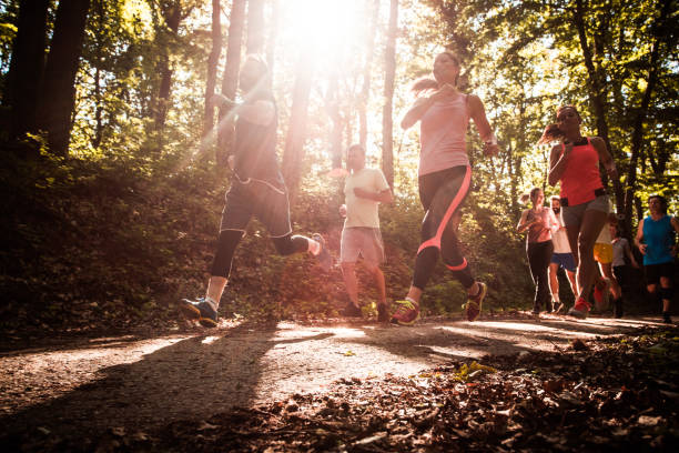 istock Below view of athletes running a marathon in the forest. 1128890171