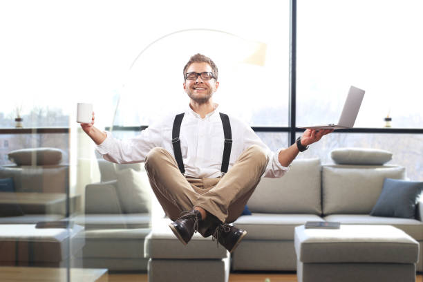 istock Young man is soaring in the air with a Cup of coffee 1128890394