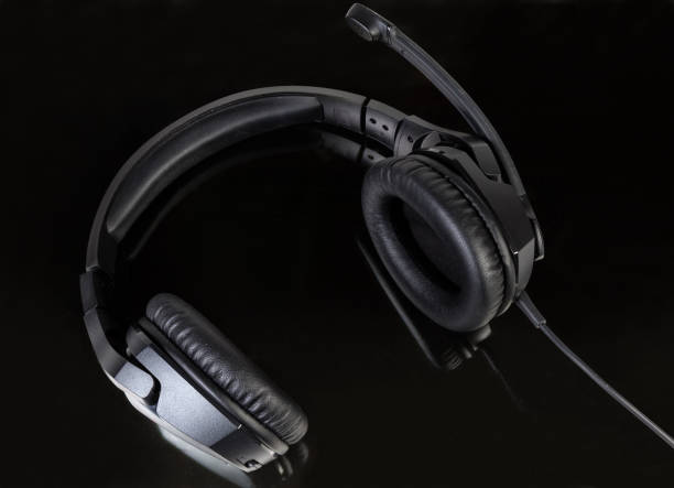 istock Black wired headset with full size headphones on dark surface 1128891000