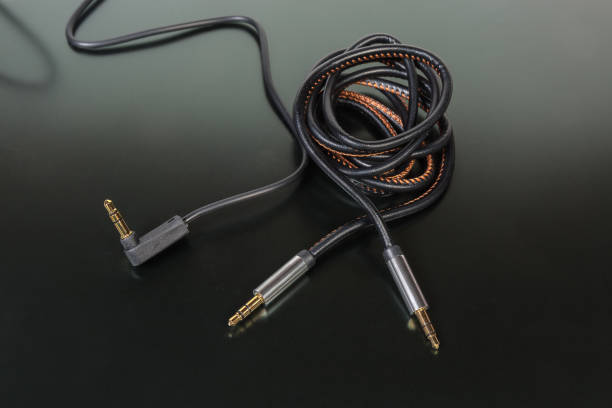 istock Analog audio cables with mini stereo connectors on dark surface 1128891161