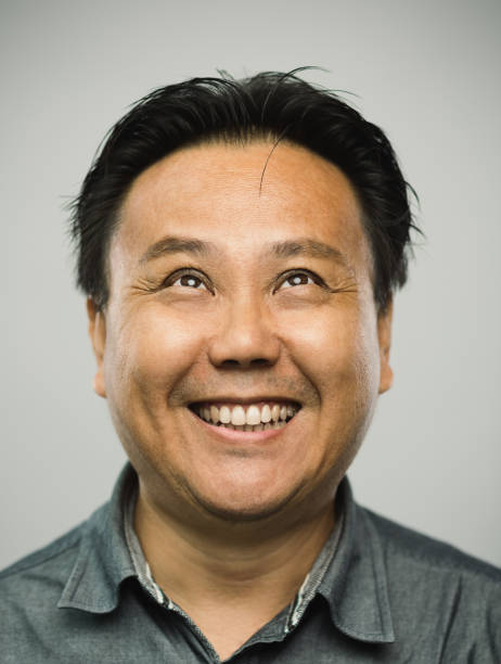 istock Real chinese mature man with excited expression looking up 1128891790