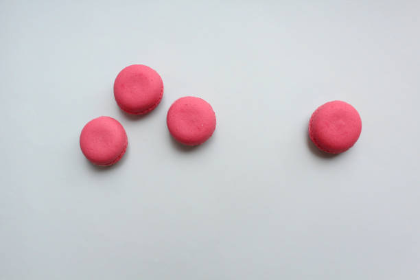 istock Four pink macaroons on a light blue background, top view 1128891874