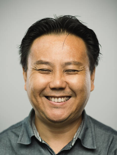 istock Real chinese mature man with excited expression and eyes closed 1128891912