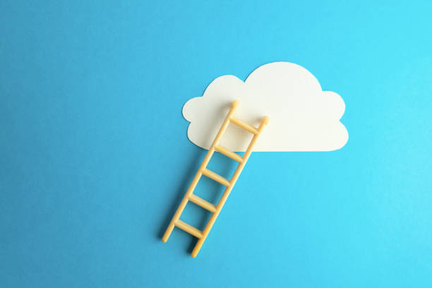 istock Stairs to the clouds on a blue background. 1128892268