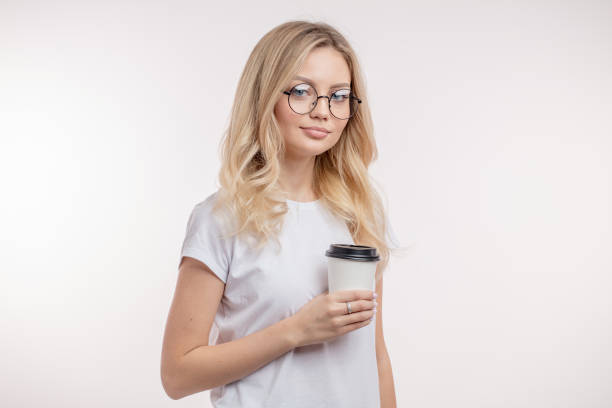 istock blonde is holding a plastic cup of coffee 1128894564