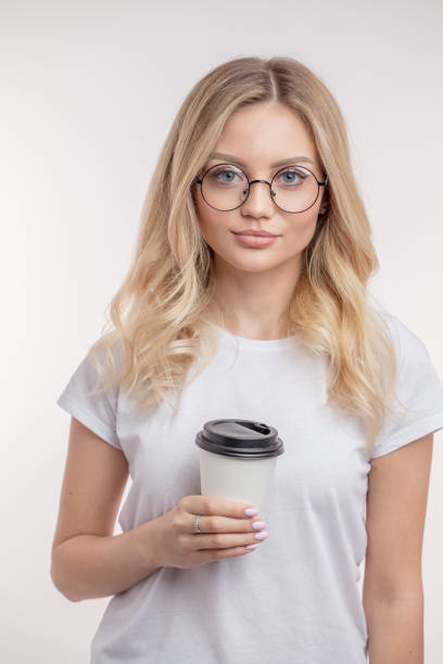 istock charming blond girl drinking hot tea 1128894642