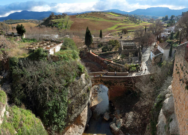 Ronda, Andalusia, Spain - January 8, 2019: fortified walls and San Miguel bridge to the Arab baths (damaged by recent floods)