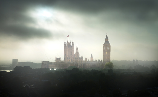 Big Ben and Houses of Parliament at dark misty day. London, UK
