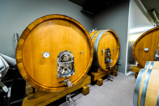 istock Wooden wine barrels stacked in modern winery cellar in Spain. 1128899213