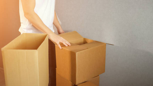 istock Young delivery service man takes cardboard Box 1128899915