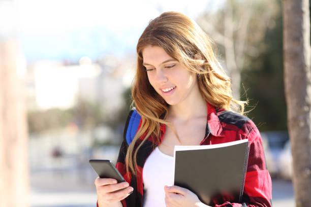istock Student is using a smart phone in the street 1128900703