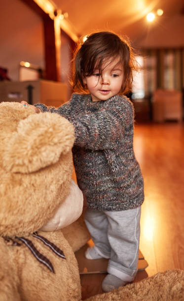 istock little girl with her fluffy bear 1128900833