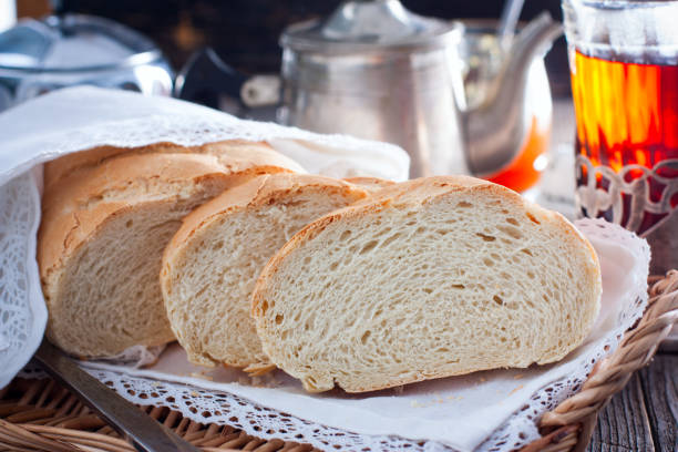 istock Homemade white bread in a rustic style, sliced, horizontal 1128902329