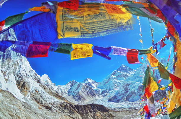 View of Mount Everest and Nuptse  with buddhist prayer flags stock photo