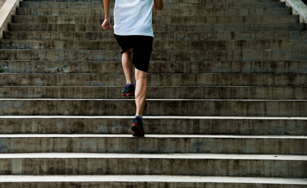 istock Man running up outdoor stairs 1128903155