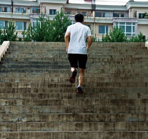 istock Man running up outdoor stairs 1128903448