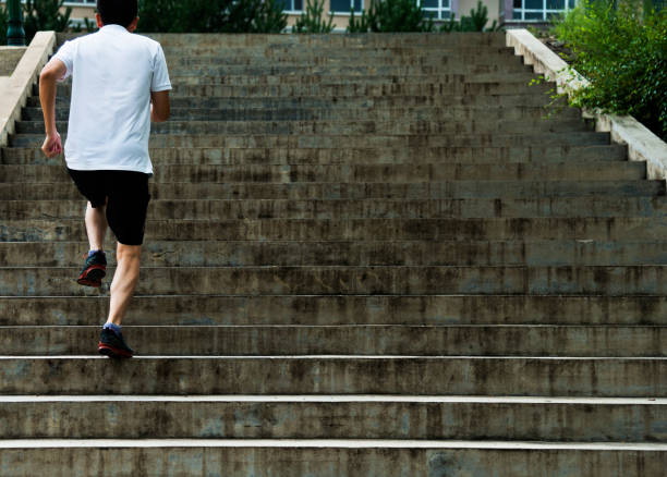 istock Man running up outdoor stairs 1128904068
