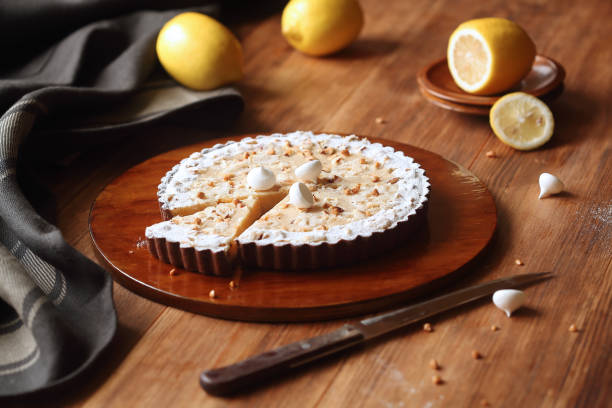 Chocolate Lemon Tart with hazelnuts and meringue cookies stock photo