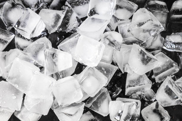 istock Ice cubes for a close-up drink on a black background. 1128905757
