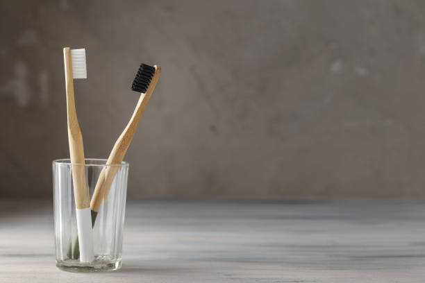 istock Two eco friendly bamboo tooth brushes in a glass 1128906232